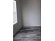 A clean and bright bedroom with modern flooring and natural light from a window at 252 Mills Ave, Troutman, NC 28166