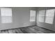 Bedroom with sleek wood floors, offering ample natural light from the windows at 252 Mills Ave, Troutman, NC 28166