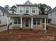 Charming home featuring a welcoming front porch and large windows at 252 Mills Ave, Troutman, NC 28166
