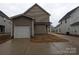 Rear exterior view showing an attached one car garage with a driveway at 252 Mills Ave, Troutman, NC 28166