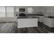 Bright kitchen featuring a center island with granite countertops and modern appliances at 252 Mills Ave, Troutman, NC 28166