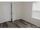 Bedroom with a window and closet, showcasing neutral walls and modern wood-look floors at 260 Mills Ave, Troutman, NC 28166