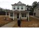 Charming two-story home with a cozy front porch and well-maintained landscaping at 260 Mills Ave, Troutman, NC 28166
