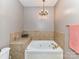 Bathroom with tub, chandelier and neutral colors at 2670 Bellasera Way, Matthews, NC 28105