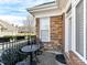 Cozy patio with brick accents and an iron table, ideal for enjoying outdoor relaxation and entertaining at 2670 Bellasera Way, Matthews, NC 28105