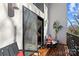 Cozy balcony with outdoor seating, wood flooring, and a view of the surrounding greenery at 2710 N Davidson St, Charlotte, NC 28205