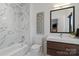 Modern bathroom featuring sleek fixtures, tub-shower combo, and a stylish vanity with storage at 2710 N Davidson St, Charlotte, NC 28205