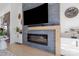 Modern fireplace with decorative tile surround, complemented by floating shelves and stylish decor in an open living space at 2710 N Davidson St, Charlotte, NC 28205