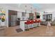 Open concept kitchen with island, seating, and pendant lights, seamlessly connecting to the living area for modern living at 2710 N Davidson St, Charlotte, NC 28205