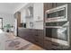 Modern kitchen featuring stainless steel appliances, sleek cabinetry, and a stylish area rug, blending form and function at 2710 N Davidson St, Charlotte, NC 28205