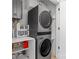 This laundry features a stacked washer and dryer and storage shelves at 2710 N Davidson St, Charlotte, NC 28205