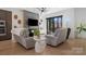 Contemporary living room with stylish seating, a modern fireplace feature wall, and sliding glass doors to the outside at 2710 N Davidson St, Charlotte, NC 28205