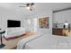 This main bedroom features a ceiling fan, a white couch, and a wet bar at 2710 N Davidson St, Charlotte, NC 28205