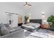 Serene main bedroom with natural light, couch, ensuite with open doorway, and ceiling fan at 2710 N Davidson St, Charlotte, NC 28205
