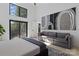 Spacious main bedroom with sliding glass door, artwork, and a plush gray sofa at 2710 N Davidson St, Charlotte, NC 28205