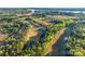 Picturesque aerial view of golf course surrounded by lush greenery and serene lakes at 27467 Cinderella Cir, Lancaster, SC 29720