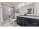 Bathroom features a tiled glass shower, double sink vanity, and decorative mirror at 27467 Cinderella Cir, Lancaster, SC 29720