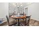 Open dining area with stylish chandelier and seamless flow to kitchen and living room at 27467 Cinderella Cir, Lancaster, SC 29720