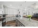 Spacious kitchen with granite countertops and stainless-steel appliances open to the living area at 27467 Cinderella Cir, Lancaster, SC 29720
