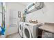 Bright laundry room features a modern washer and dryer, storage shelves, and neutral tones at 27467 Cinderella Cir, Lancaster, SC 29720