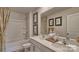 Bright bathroom featuring double sinks, white cabinets, tub-shower, framed art, and stylish décor at 3060 Ora Smith Rd, Lincolnton, NC 28092
