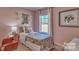 This cozy pink bedroom features modern decor, neutral walls and a window with natural light at 3060 Ora Smith Rd, Lincolnton, NC 28092