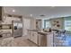 Open kitchen with stainless steel appliances, granite countertops, an island with seating, and access to the dining area at 3060 Ora Smith Rd, Lincolnton, NC 28092