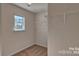 This functional walk-in closet has wall-mounted shelving and natural light from the window at 3060 Ora Smith Rd, Lincolnton, NC 28092