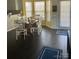 Bright dining area featuring dark hardwood floors, a table with seating for six, and sunny windows at 3626 Cole Mill Rd, Charlotte, NC 28270