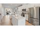 Modern kitchen featuring stainless steel appliances, a kitchen island, and an open layout to the dining area at 3729 S Tryon St, Charlotte, NC 28217