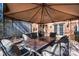 Backyard patio with a tented table and chair set, grill and brick wall at 4151 Ivystone Ct, Charlotte, NC 28277