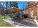 Backyard patio area with a large tented table and chairs, grill and access to the home at 4151 Ivystone Ct, Charlotte, NC 28277