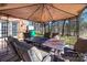 Backyard patio featuring tented table and chair set, view of the back yard and trees at 4151 Ivystone Ct, Charlotte, NC 28277