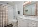 Bathroom featuring a shower-tub combo, marble tile, mosaic mirror, and vanity at 4151 Ivystone Ct, Charlotte, NC 28277