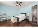 Stylish bedroom featuring a bed, vanity, hardwood floors, and natural lighting at 4151 Ivystone Ct, Charlotte, NC 28277