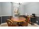 Cozy dining area with wood table, four chairs, and natural light from the window at 4151 Ivystone Ct, Charlotte, NC 28277