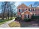 Traditional brick exterior with black shutters, complemented by a green lawn and mature trees at 4151 Ivystone Ct, Charlotte, NC 28277