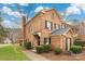 Beautiful brick townhome with a chimney, green grass, and black shutters at 4151 Ivystone Ct, Charlotte, NC 28277