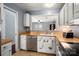 Functional kitchen with stainless steel appliances, white cabinets, and a view into the living area at 4151 Ivystone Ct, Charlotte, NC 28277