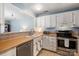 Well-lit kitchen featuring white cabinetry, stainless steel appliances, and laminate countertops at 4151 Ivystone Ct, Charlotte, NC 28277