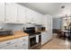 Bright kitchen with white cabinets, stainless steel appliances, and tile flooring at 4151 Ivystone Ct, Charlotte, NC 28277
