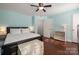A spacious bedroom featuring light blue walls, hardwood floors, and a ceiling fan with light at 4151 Ivystone Ct, Charlotte, NC 28277