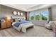 A stylish main bedroom with a large window, bench and neutral color palette offering a serene and modern feel at 4391 Reed Creek Dr, Sherrills Ford, NC 28673