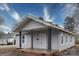 Charming single-story home featuring a covered porch with decorative support columns at 572 2Nd St, Chester, SC 29706