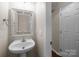 Half bathroom features a large vanity, framed mirror and an adjacent door to another room at 604 Atherton Way, Rock Hill, SC 29730