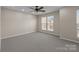 Spacious bedroom featuring two windows, a ceiling fan and neutral carpet at 604 Atherton Way, Rock Hill, SC 29730