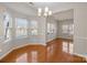 Open dining room with hardwood floors, modern lighting, and large windows at 604 Atherton Way, Rock Hill, SC 29730