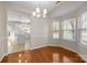 Open dining room with hardwood floors and modern light fixture next to the kitchen at 604 Atherton Way, Rock Hill, SC 29730