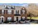 Charming two-story brick townhouse featuring a black awning and dormer windows at 604 Atherton Way, Rock Hill, SC 29730