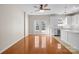 Open-concept kitchen featuring white cabinets, stainless steel appliances, and hardwood floors at 604 Atherton Way, Rock Hill, SC 29730